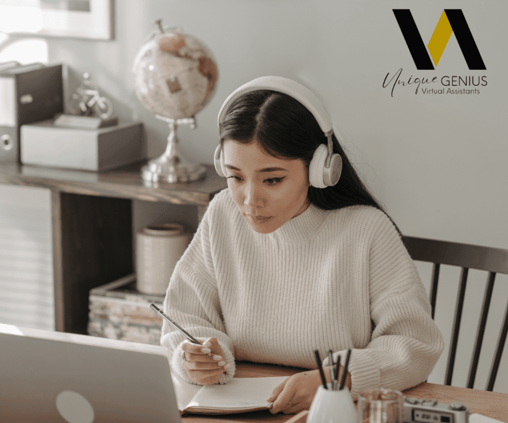 asian woman with a headphone writing notes while working on her laptop - unique genius