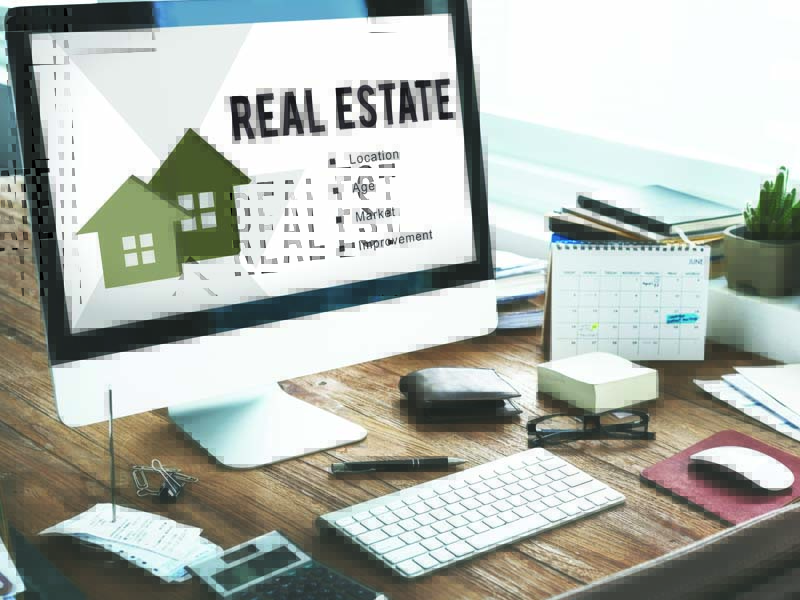 a desktop with the text: "Real Estate" - unique genius