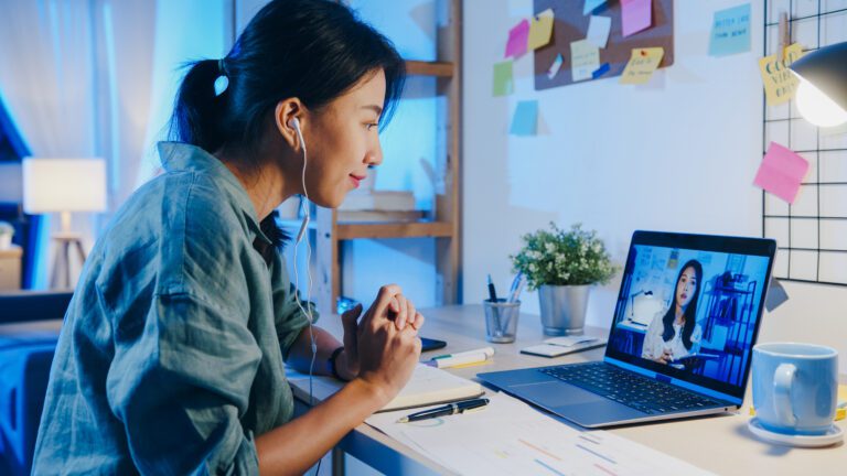 asia businesswoman using laptop talk colleagues about plan video call meeting living room