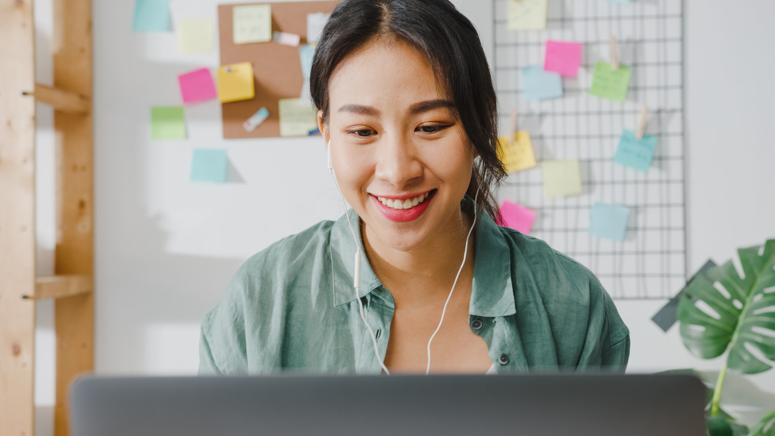 asia businesswoman using laptop talk colleagues about plan video call while smart working from home living room scaled