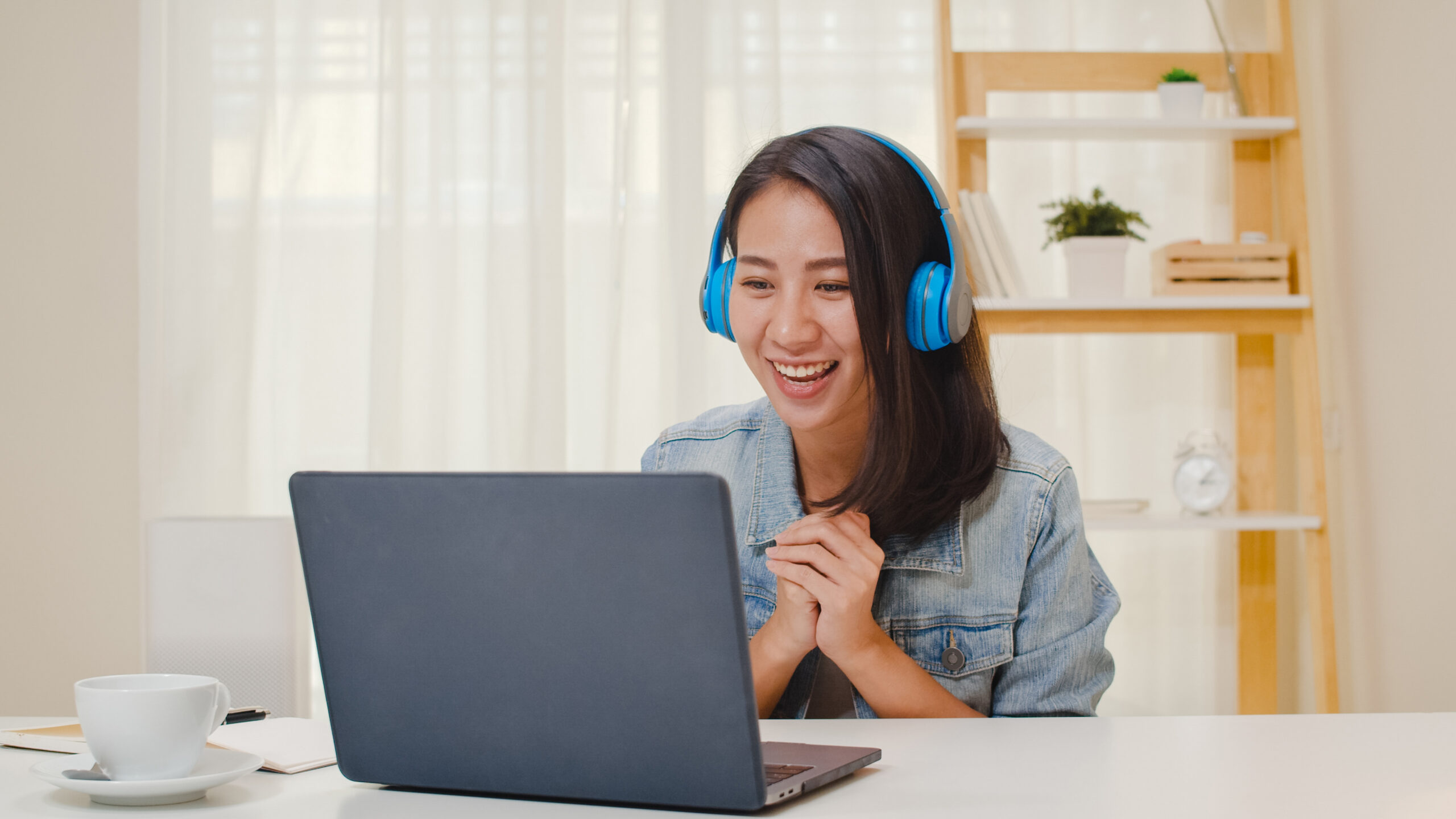freelance business women casual wear using laptop working call video conference with customer workplace living room home happy young asian girl relax sitting desk job internet scaled