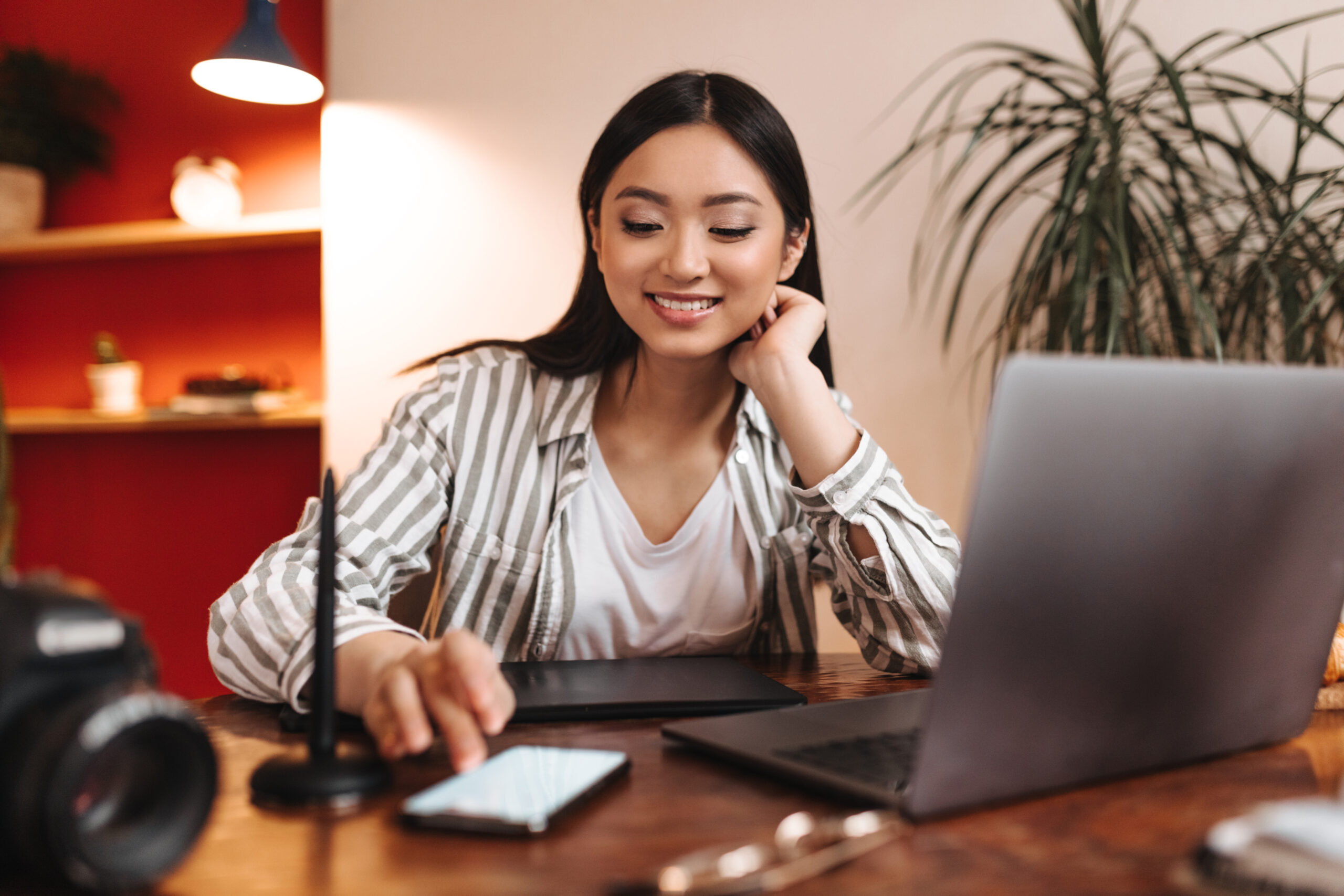 young business woman smiles looks into phone screen scaled