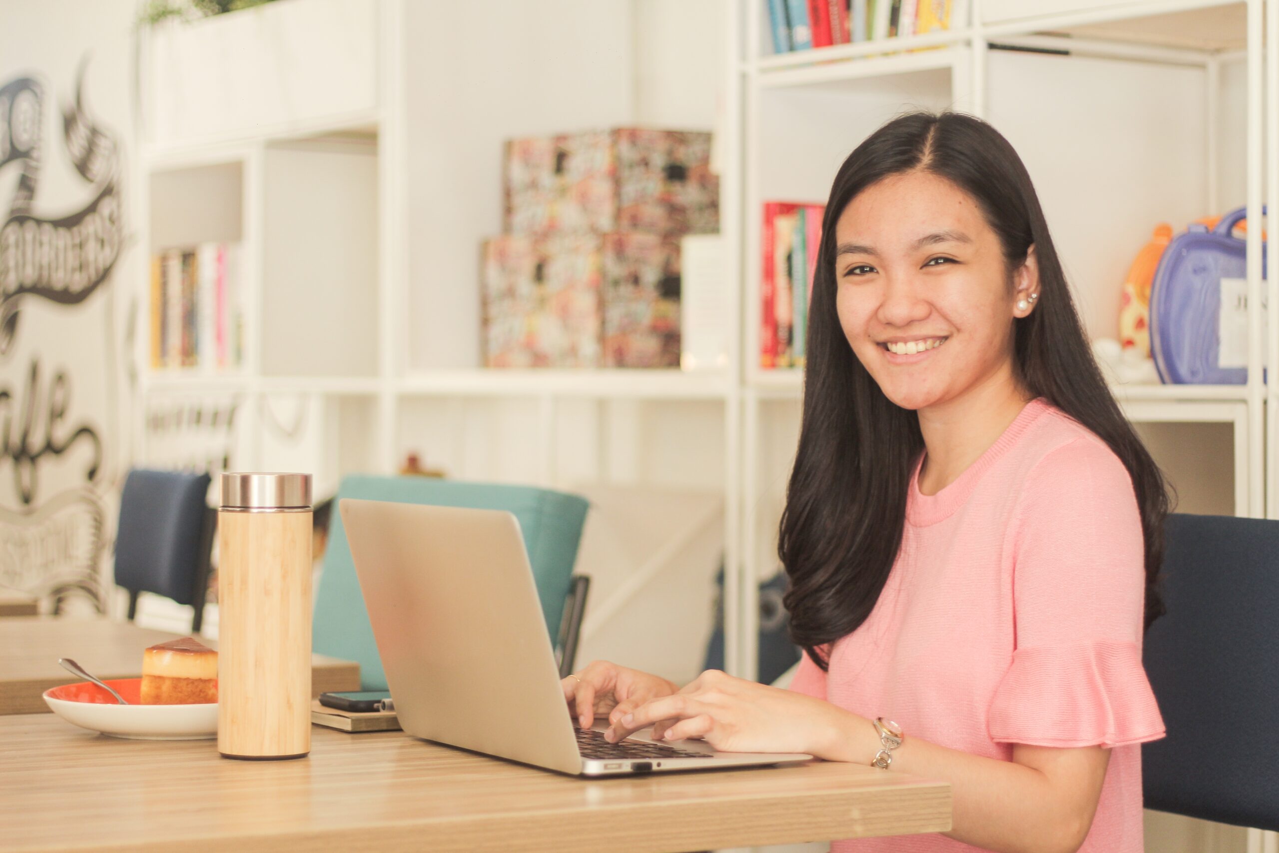 black haired lady sitting front her laptop office scaled