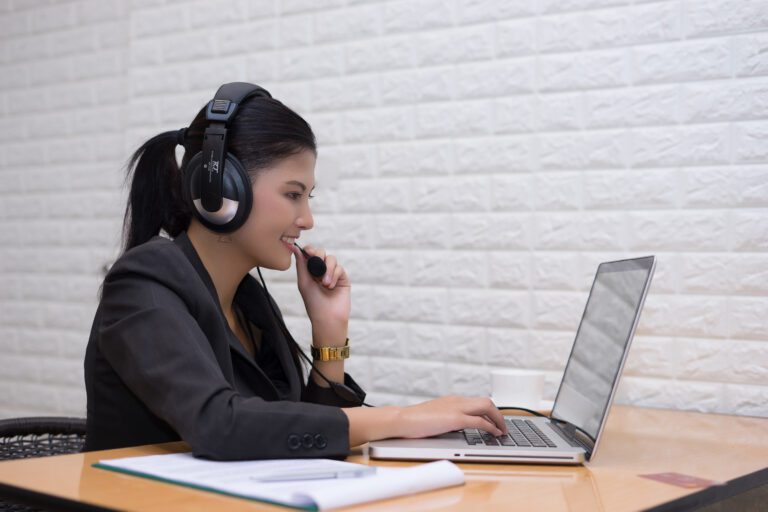 young businesswoman with headset sitting office table
